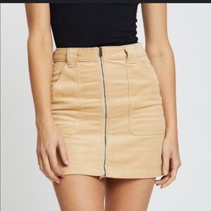 Hollister Ultra High-Rise corduroy mini skirt in a beige or tan color.